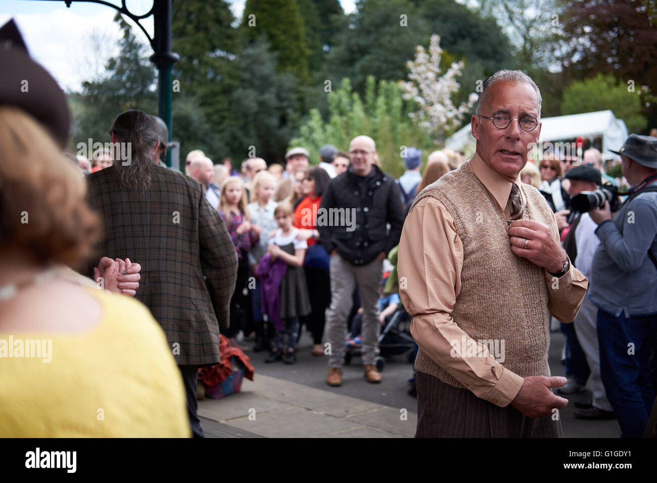 Older gentleman, dressed in 1940s vintage clothing, looks toward off-camera partner during a swing dance. Stock Photo