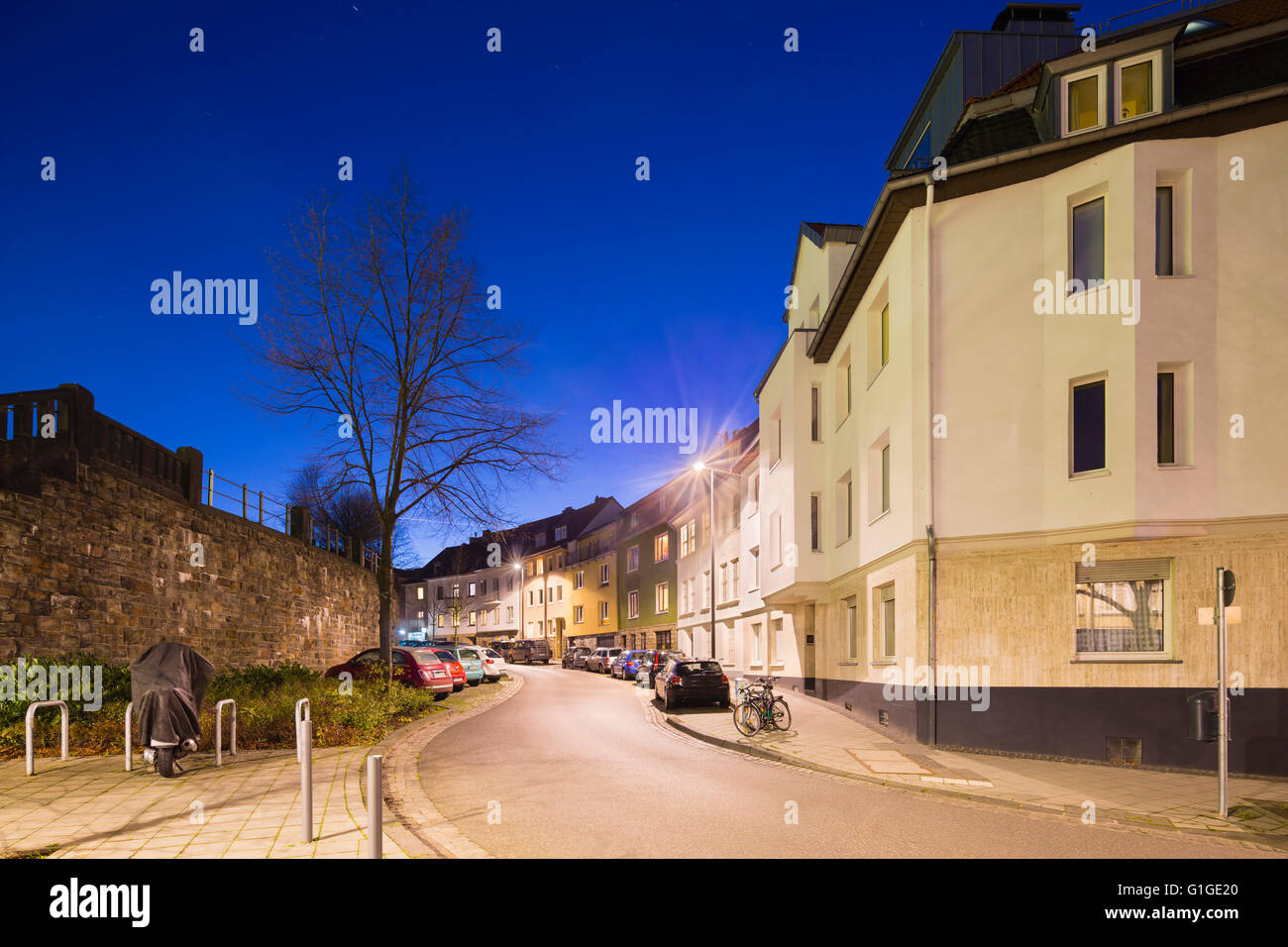 A city street in Aachen Burtscheid, Germany with night blue sky. Stock Photo