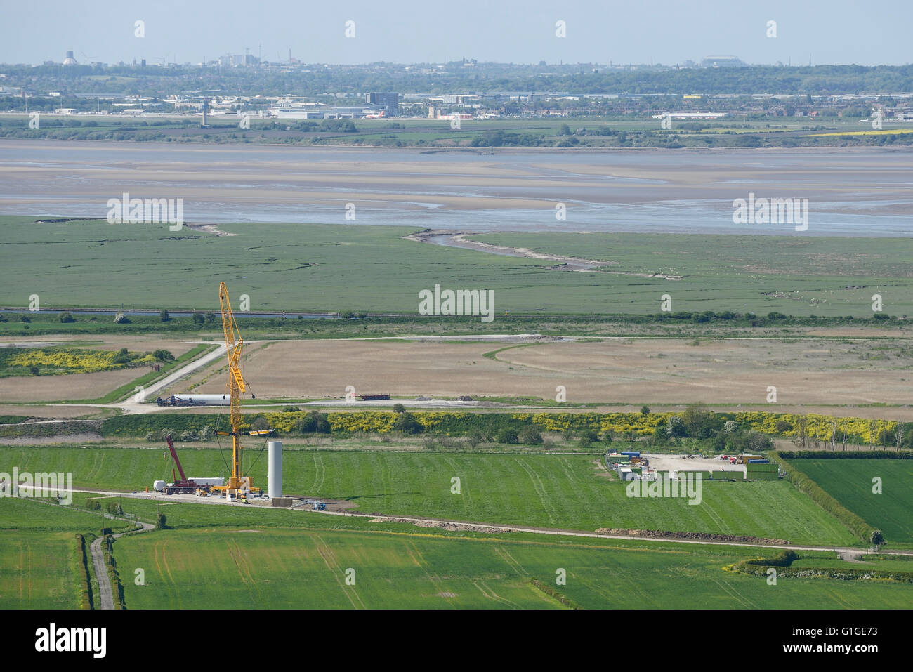 View across the Mersey Estuary from Helsby Hill towards Liverpool with construction of the Frodsham Wind Farm project Stock Photo