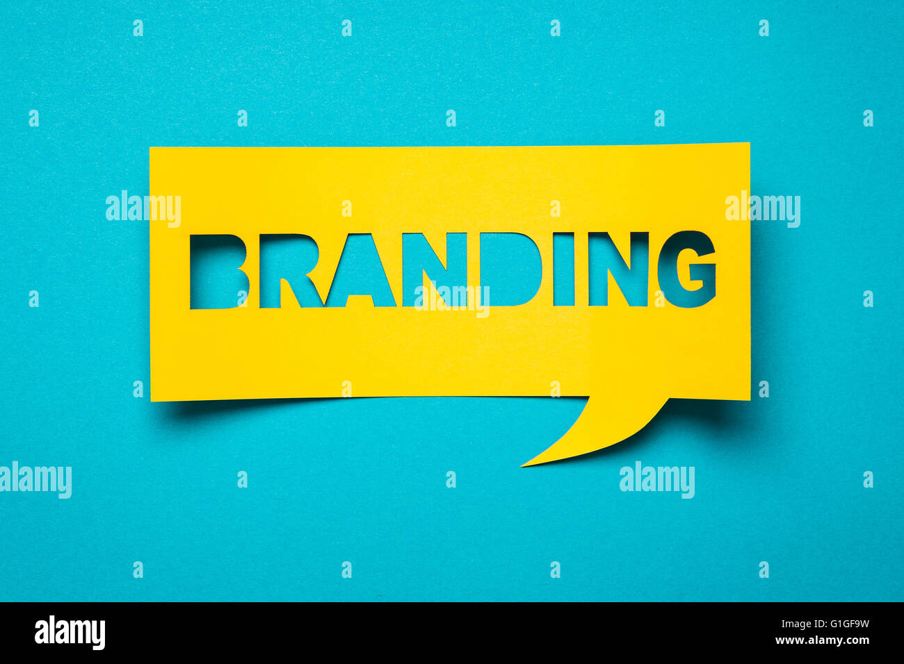 Bubble speech with cut out phrase 'branding' in the paper. Stock Photo