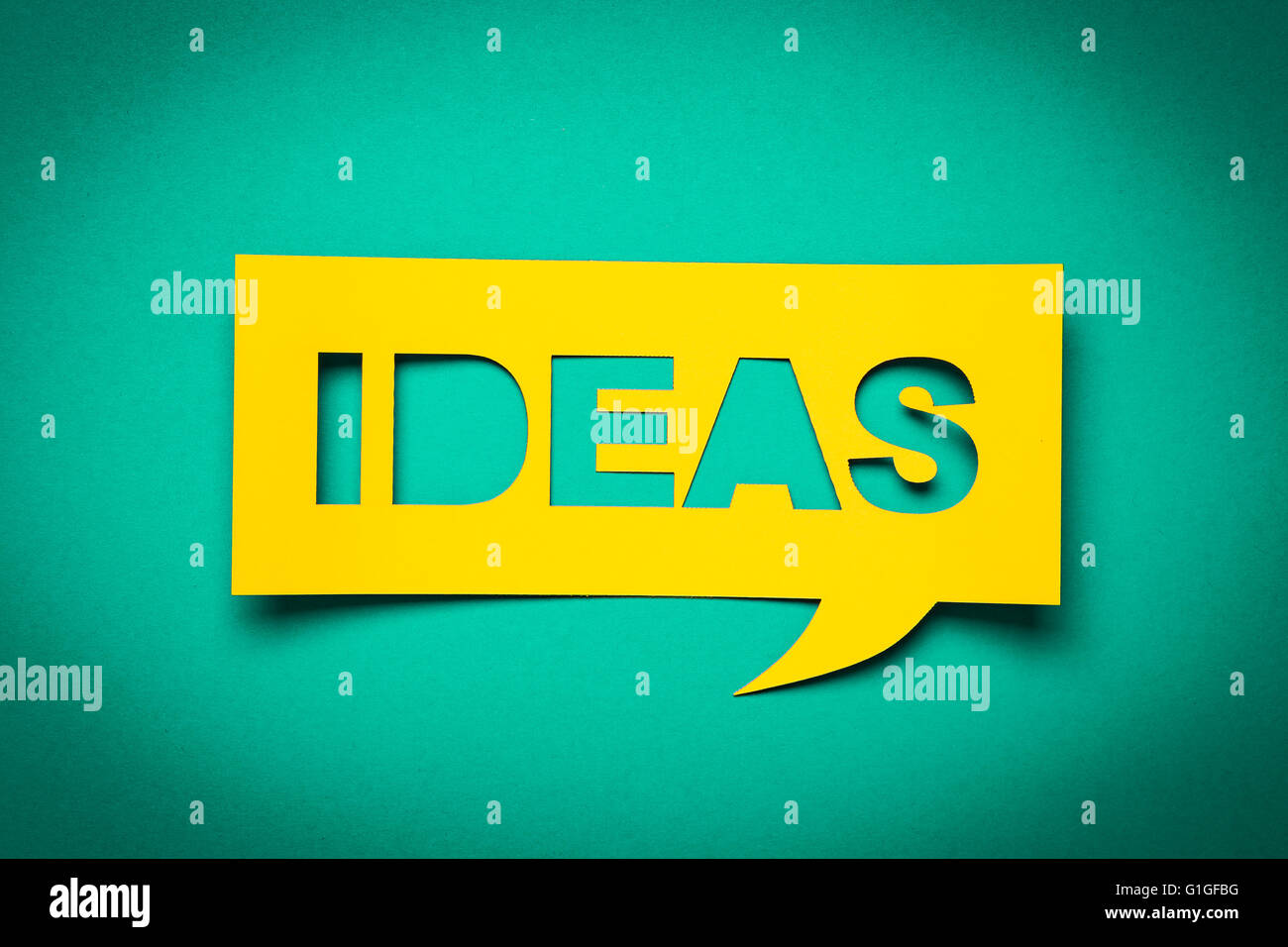 Bubble speech with cut out phrase "ideas" in the paper. Stock Photo