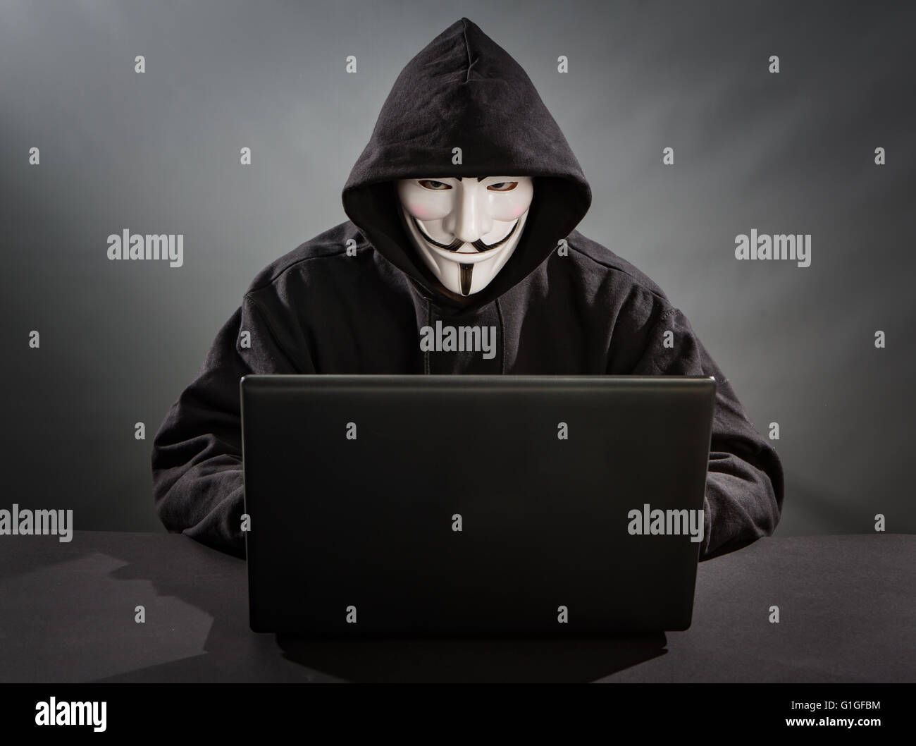 Bełchatow, Poland - December 18, 2015: Man with the laptop wearing Vendetta mask - symbol for the online hacktivist group Anonym Stock Photo