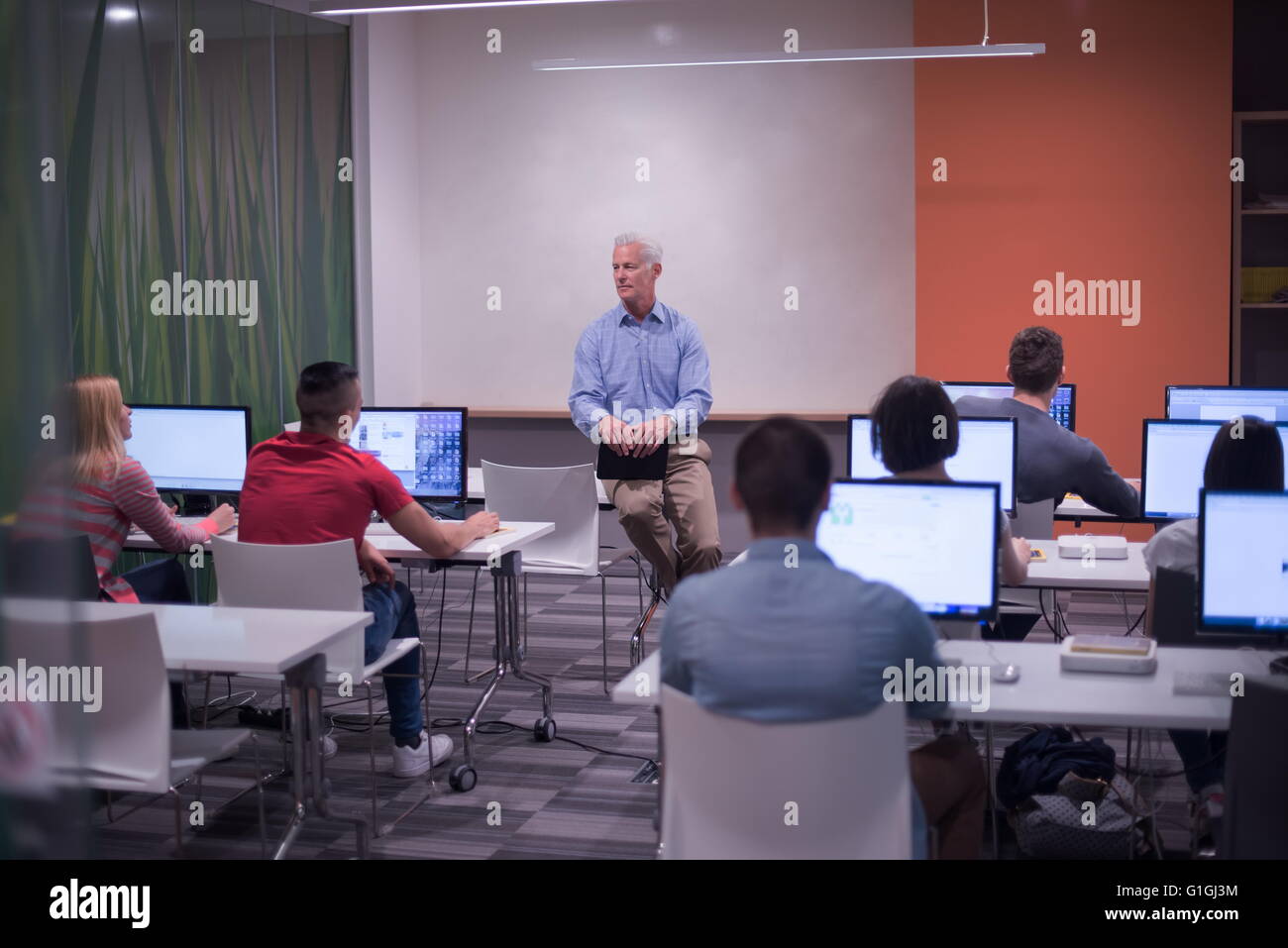 handsome mature teacher and students in computer lab classroom Stock ...