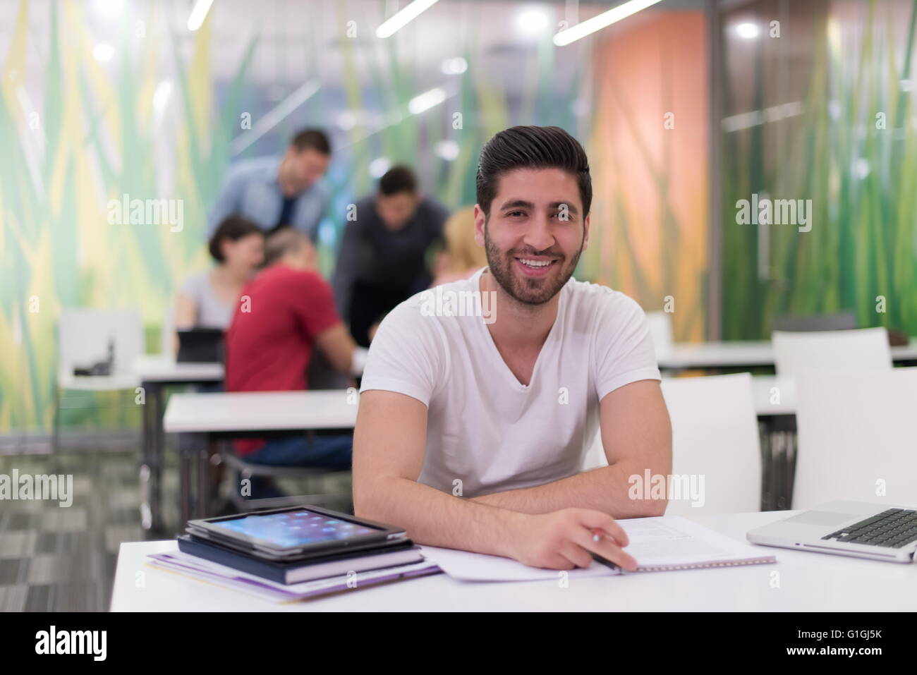 male student in classroom working homework and learning with laptop ...