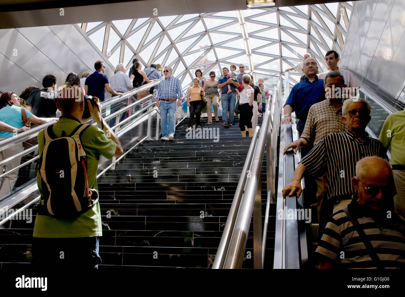 Man taking photos in the new station escalator. Puerta del Sol, Madrid. Spain. Stock Photo