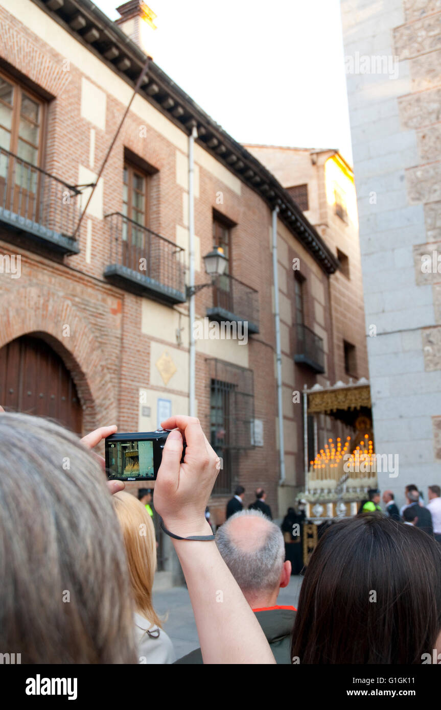 Woman photographing the Holy Week procession. Plaza de la Villa, Madrid, Spain. Stock Photo