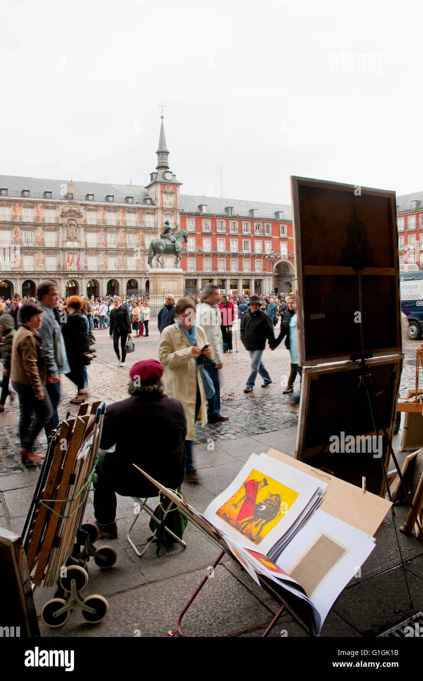 Artist with his paintings at Main Square. Madrid, Spain. Stock Photo