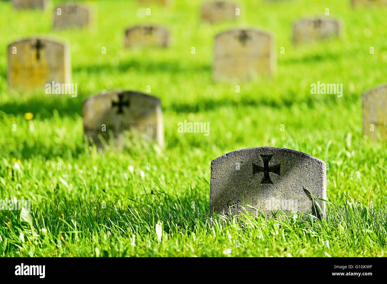 Gravestone of a german soldier with the iron cross symbol in a heroes graveyard Stock Photo