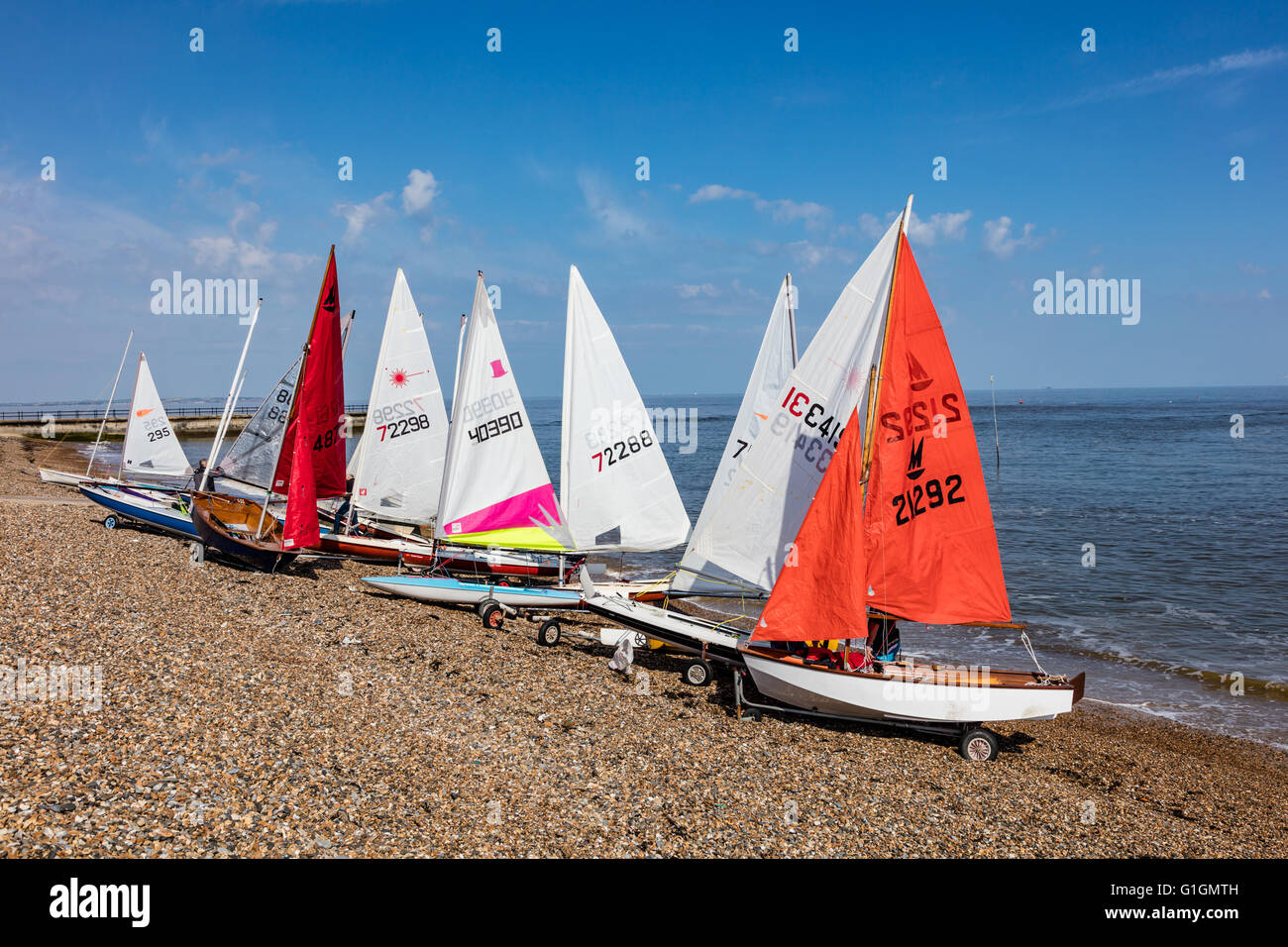 Dinghy sailors prepare for a morning race on the beach at Hampton, Herne Bay, Kent, UK Stock Photo