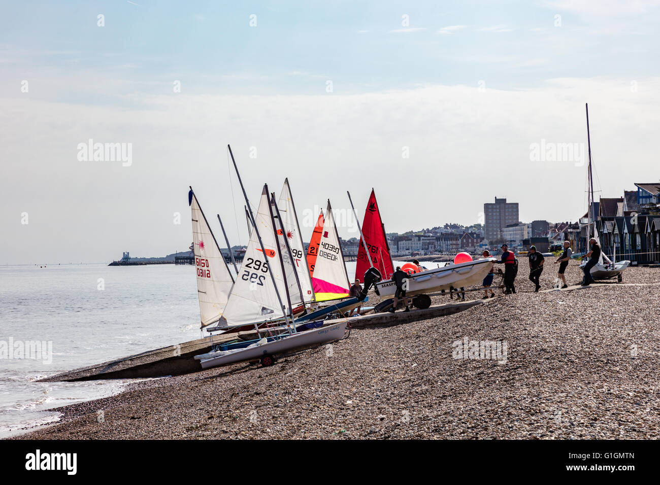 Dinghy sailors prepare for a morning race on the beach at Hampton, Herne Bay, Kent, UK Stock Photo