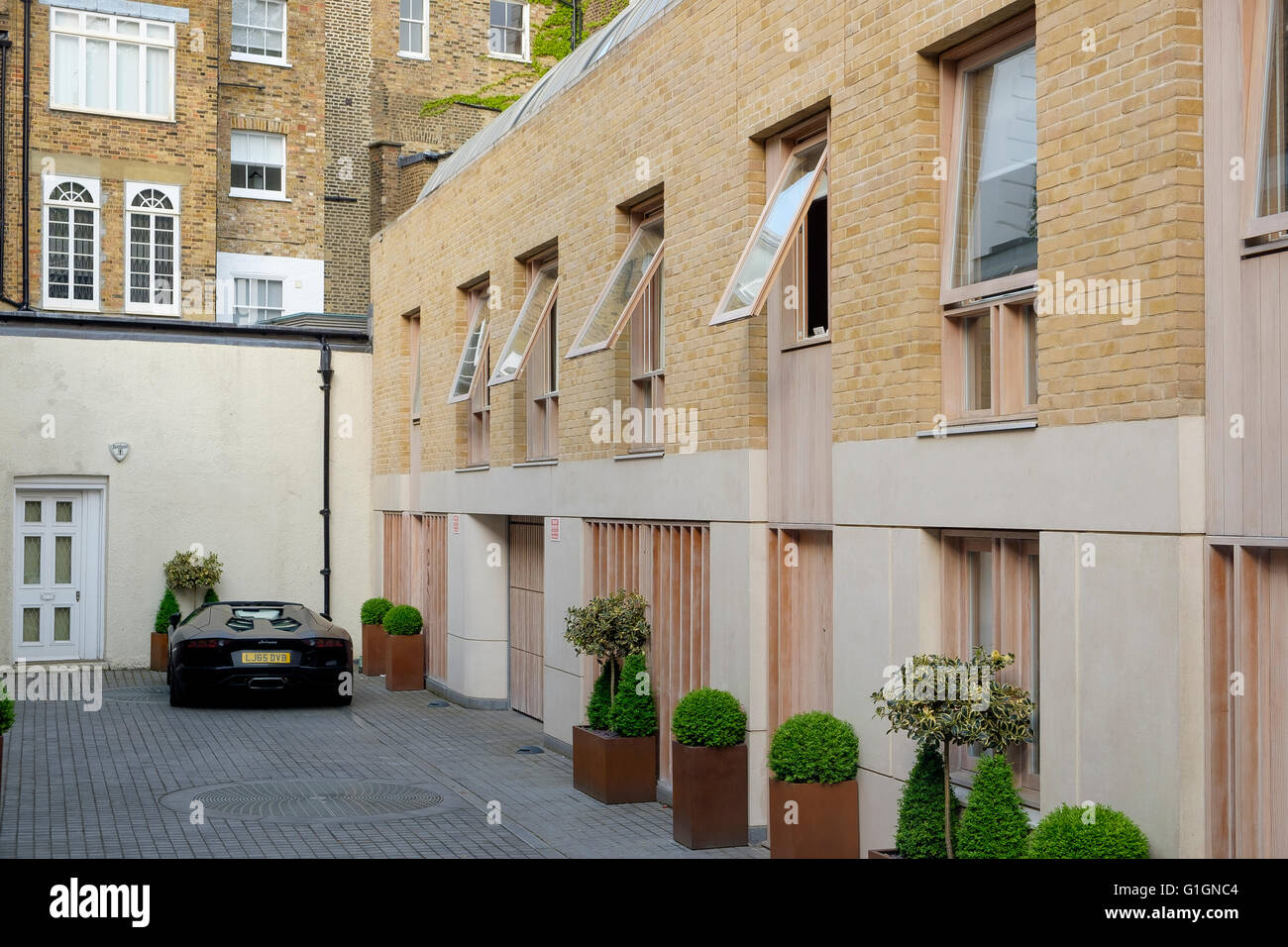 Modern Mews houses and a parked Lamborghini  off Yeoman's Row, Knightsbridge, London Stock Photo