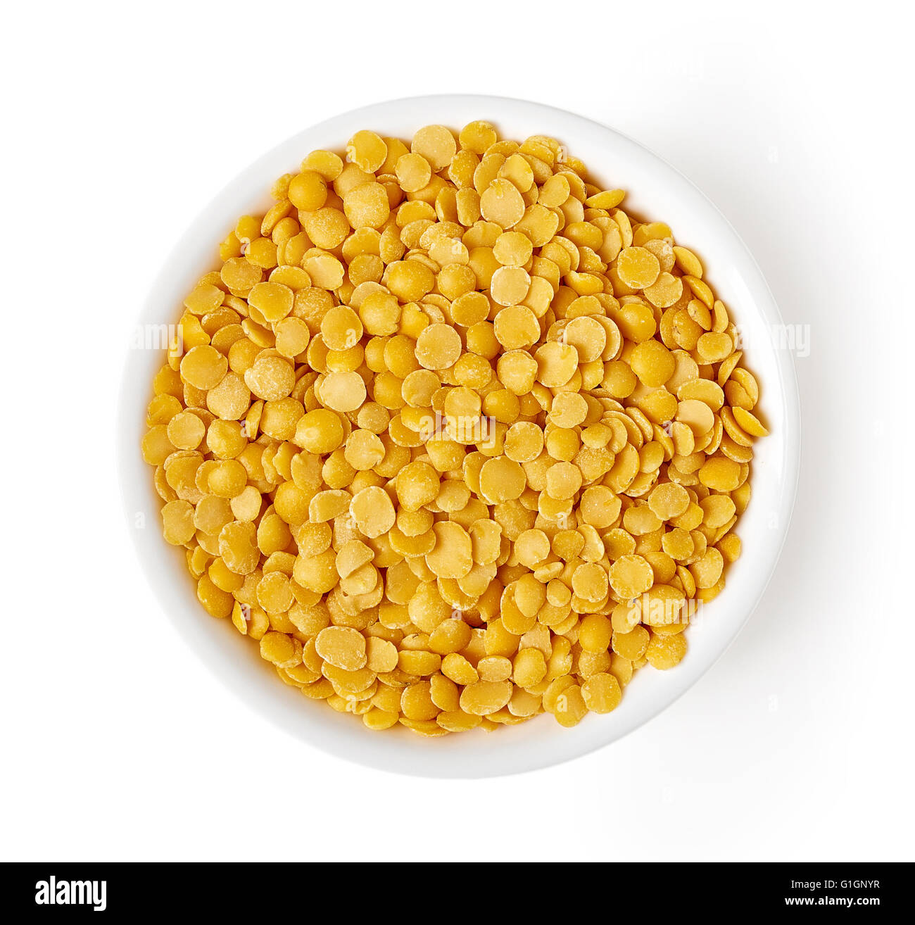 Bowl of yellow split lentil isolated on white background, top view