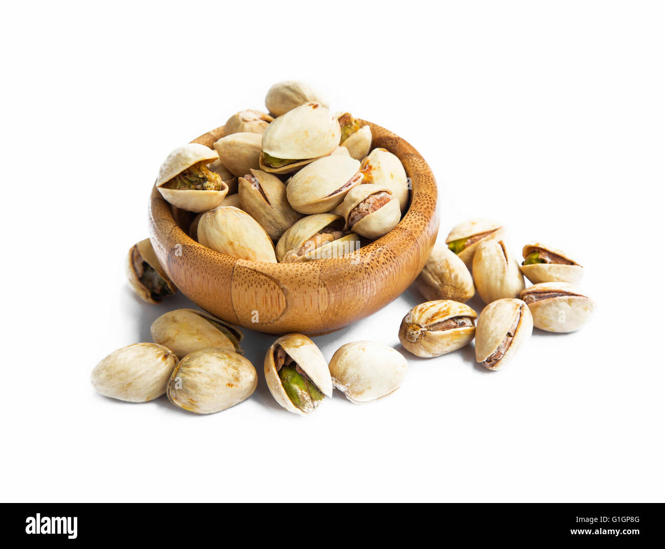 Pistachio nuts in little bowl isolated Stock Photo