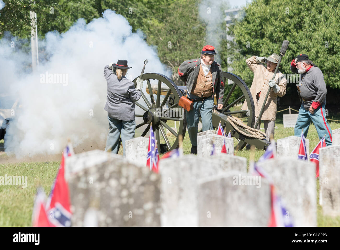 Charleston, USA. 14th May, 2016. Confederate re-enactors fire a canon salute to honor the Civil War dead during a memorial service to mark Confederate Memorial Day  at Magnolia Cemetery May 14, 2016 in Charleston, South Carolina. The events marking southern Confederate heritage come nearly a year after the removal of the confederate flag from the capitol following the murder of nine people at the historic black Mother Emanuel AME Church. Credit:  Planetpix/Alamy Live News Stock Photo