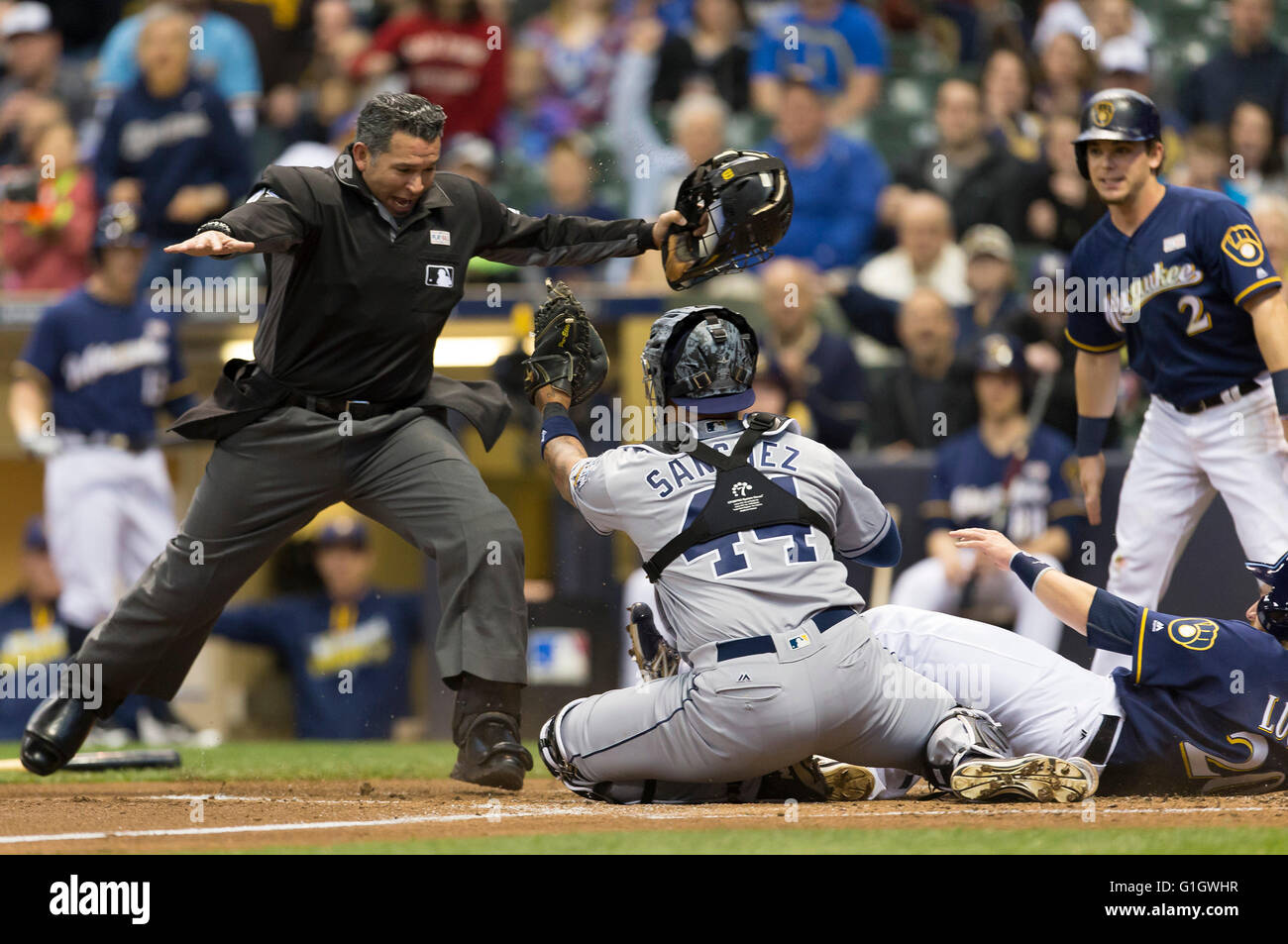 Milwaukee, WI, USA. 14th May, 2016. Home plate umpire Manny Gonzalez calls Milwaukee Brewers runner Jonathan Lucroy #20 safe as San Diego Padres catcher Hector Sanchez #44 shows the tag in the Major League Baseball game between the Milwaukee Brewers and the San Diego Padres at Miller Park in Milwaukee, WI. John Fisher/CSM/Alamy Live News Stock Photo
