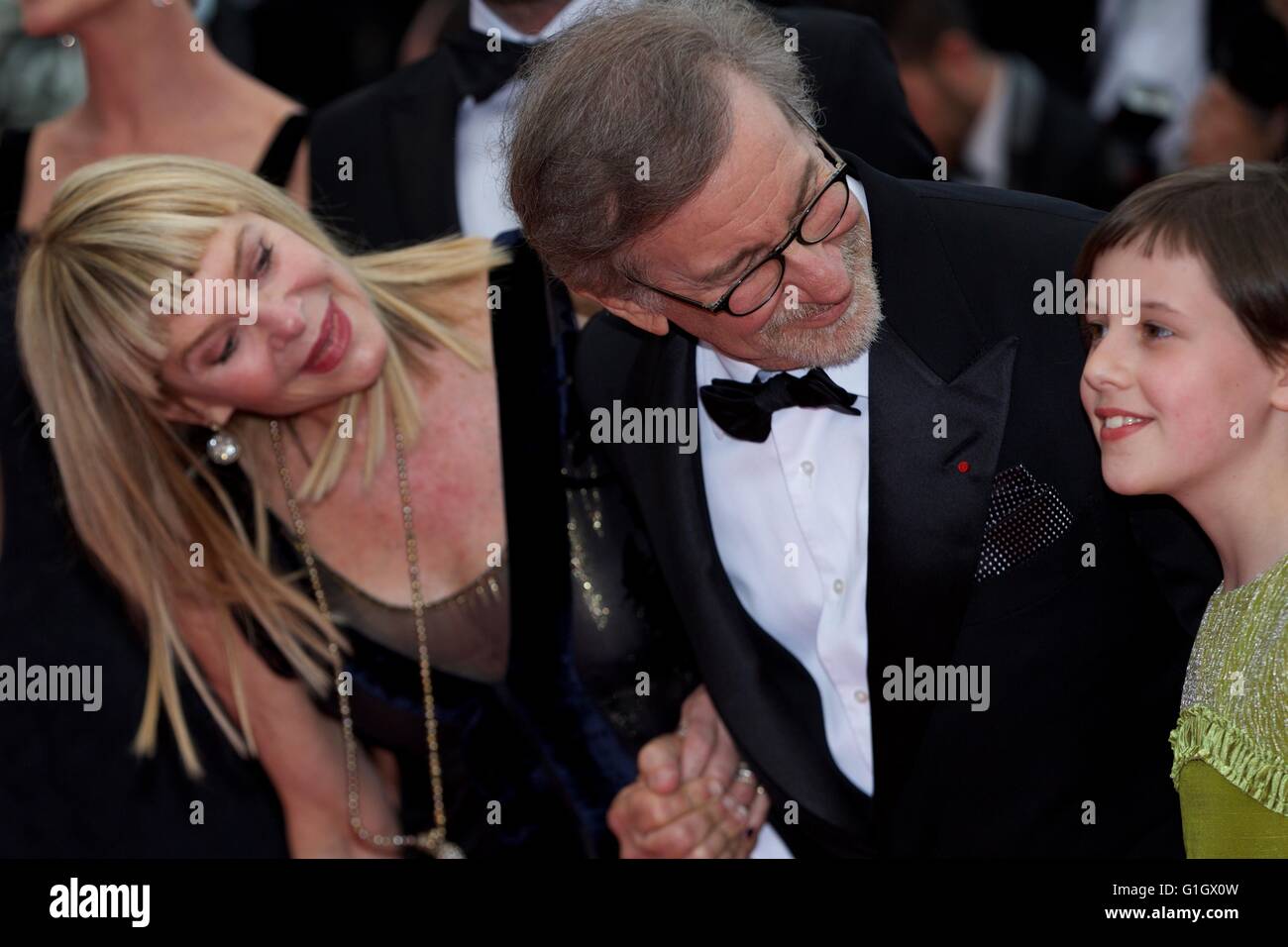 (160515) -- CANNES, May 15, 2016 (Xinhua) -- Director Steven Spielberg (C), his wife Kate Capshaw (L) and cast member Ruby Barnhill (R) pose on the red carpet as they arrive for the screening of the film 'The BFG' at the 69th Cannes Film Festival in Cannes, France, May 14, 2016.(Xinhua/Jin Yu) Stock Photo