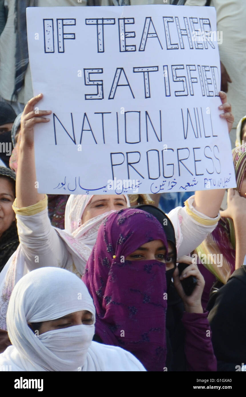 Woman raising placard during a rally in Lahore. Pakistani teachers hold