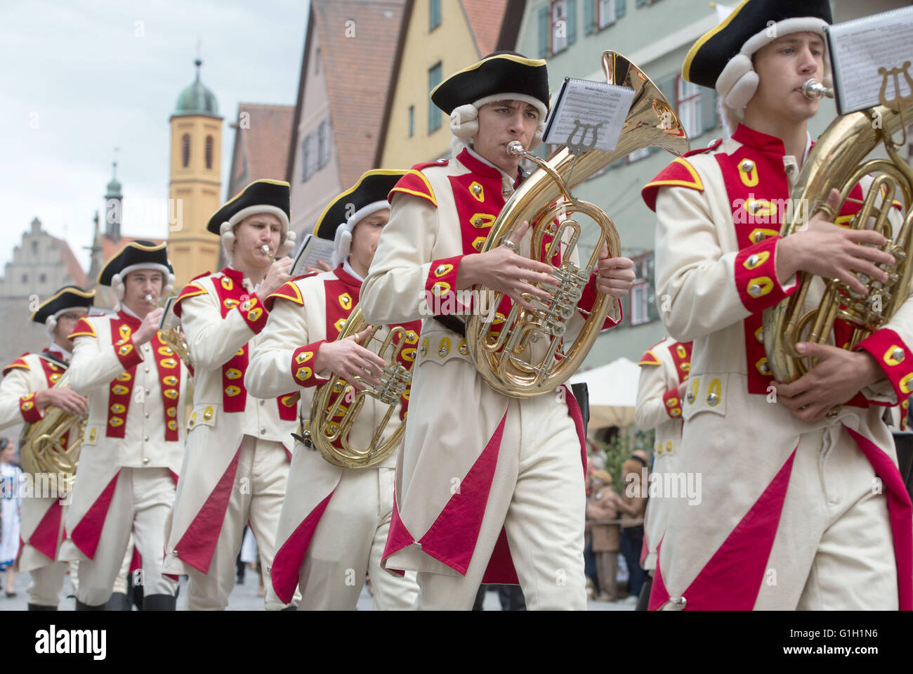A brass band in traditional costume moves through the city during the Transylvanian Saxons