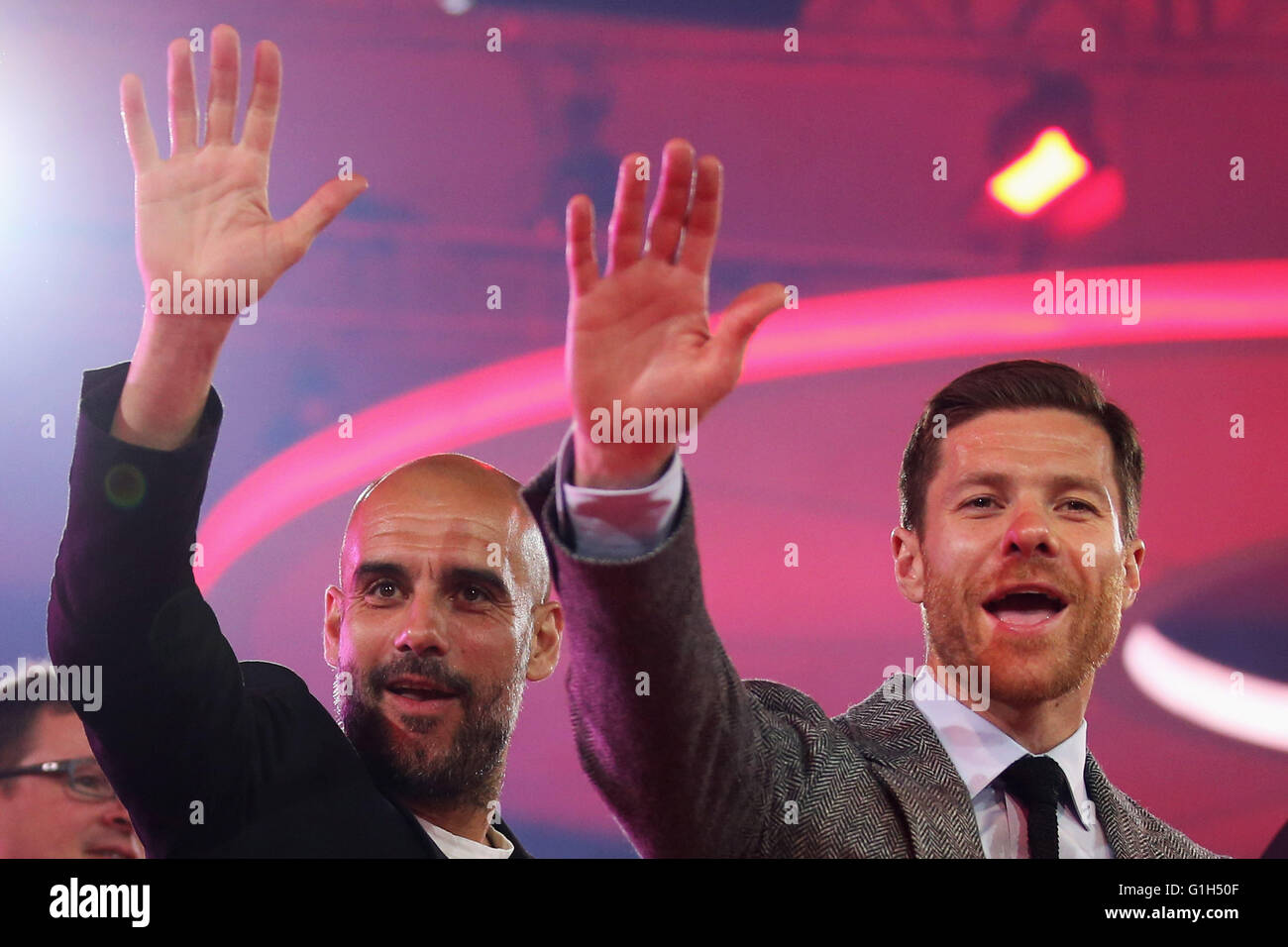 Munich, Germany. 14th May, 2016. Head Coach, Pep Guardiola (L) and Xabi Alonso wave on stage during the FC Bayern Muenchen Bundesliga Champions Dinner at the Postpalast on May 14, 2016 in Munich, Bavaria. Stock Photo