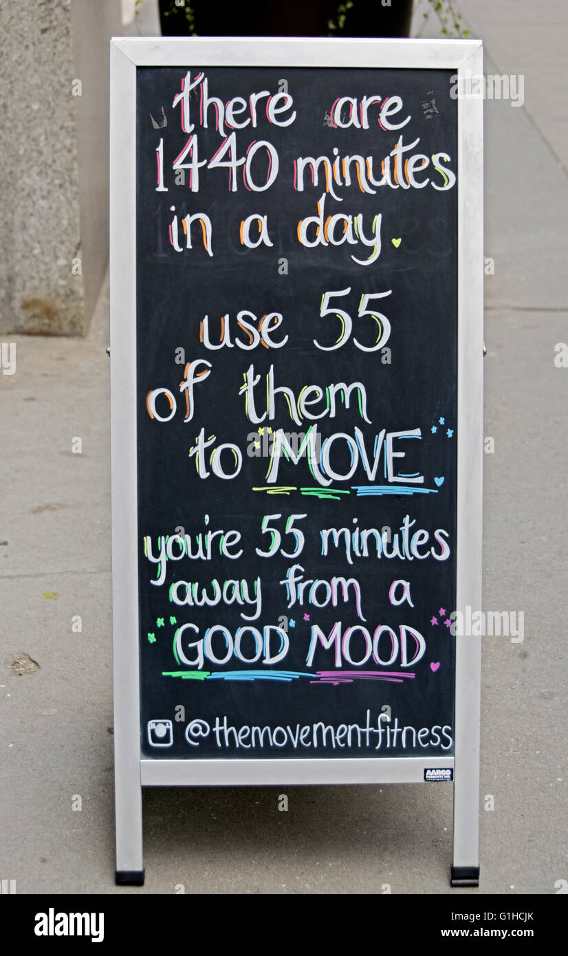 A sign in front of THE MOVEMENT fitness boutique encouraging people to join their club and exercise regularly. New York City. Stock Photo