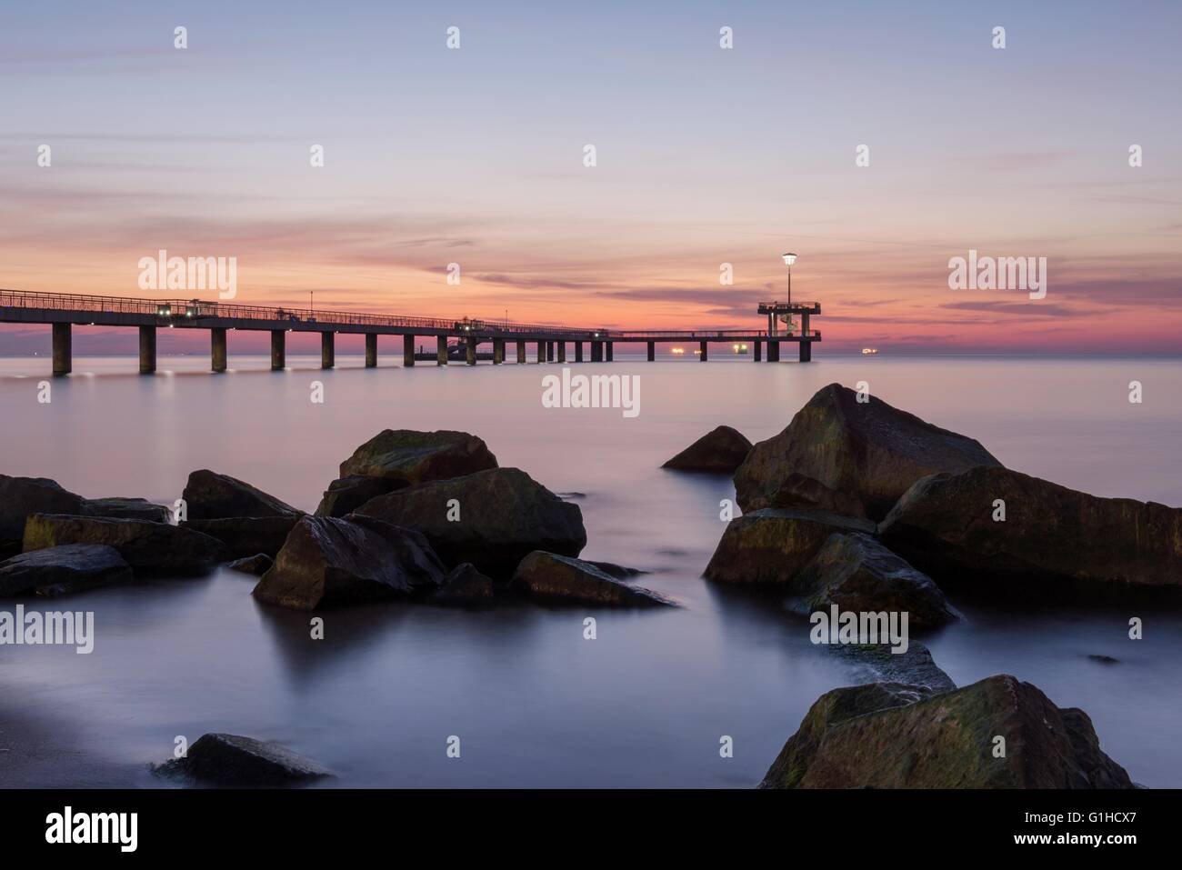 Sunrise over the sea bridge in Burgas bay, Bulgaria Stock Photo