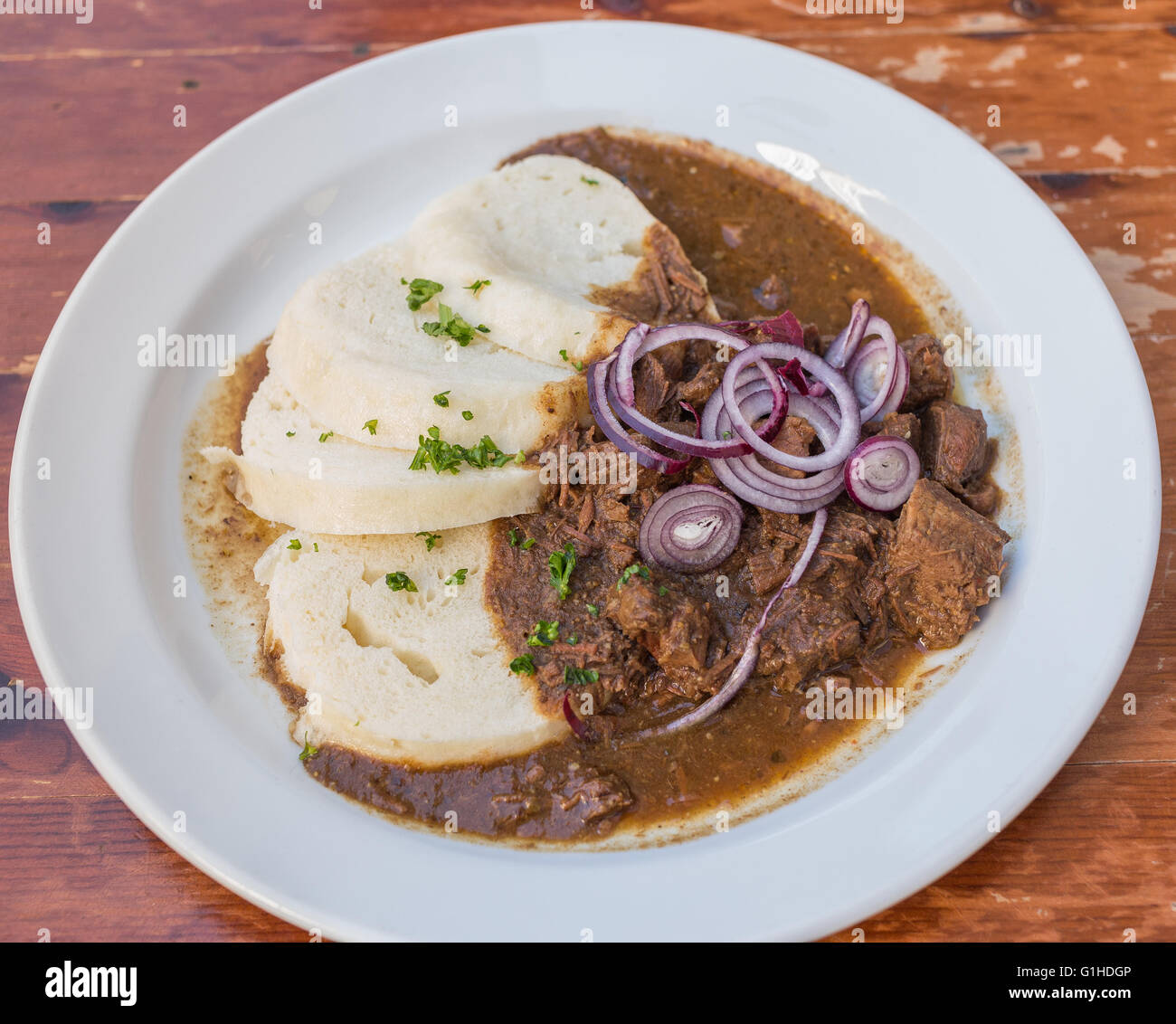 Typical serving of Beef Goulash and Bread Dumplings Stock Photo