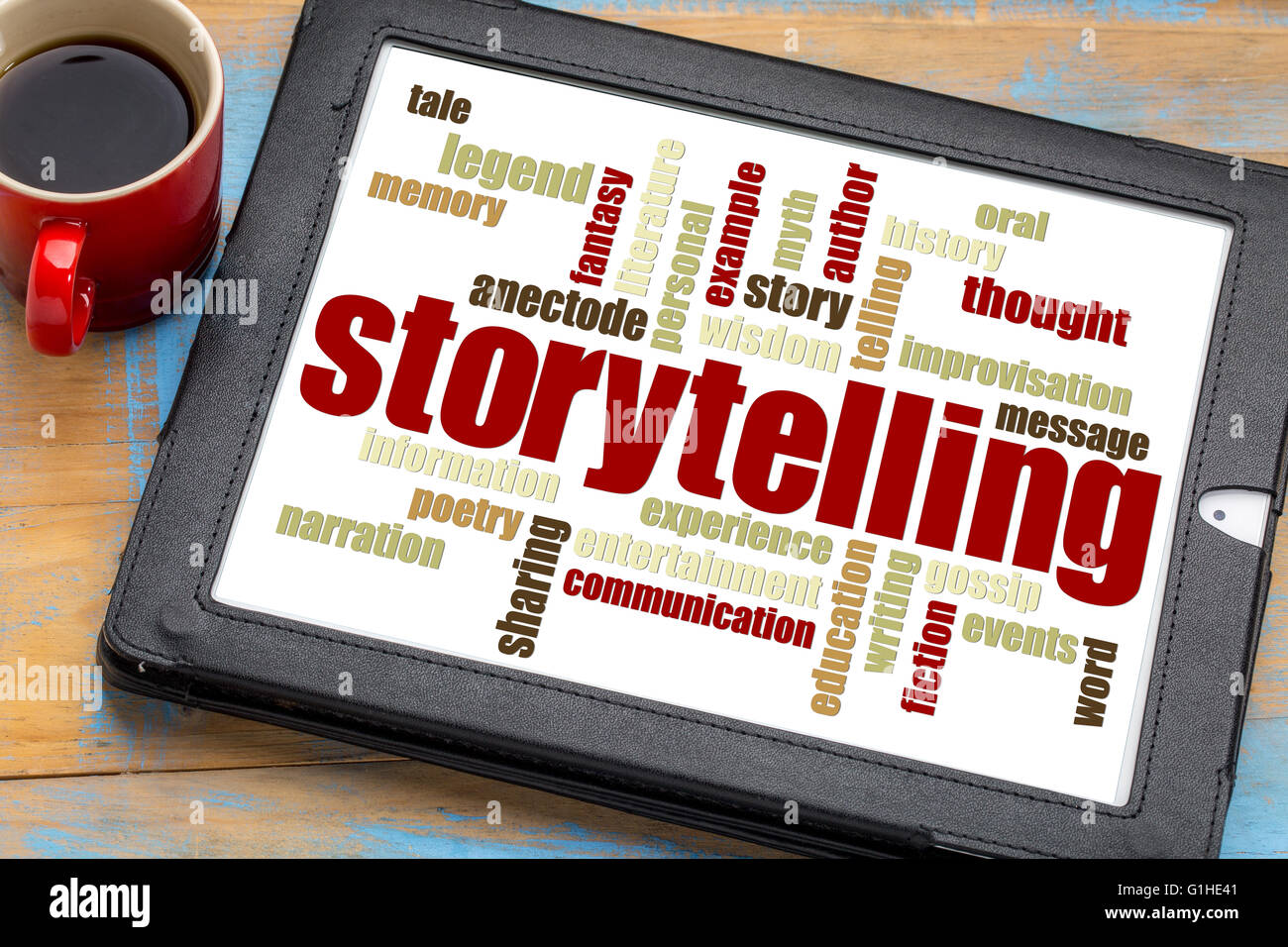 storytelling word cloud on a digital tablet with a cup of coffee Stock Photo