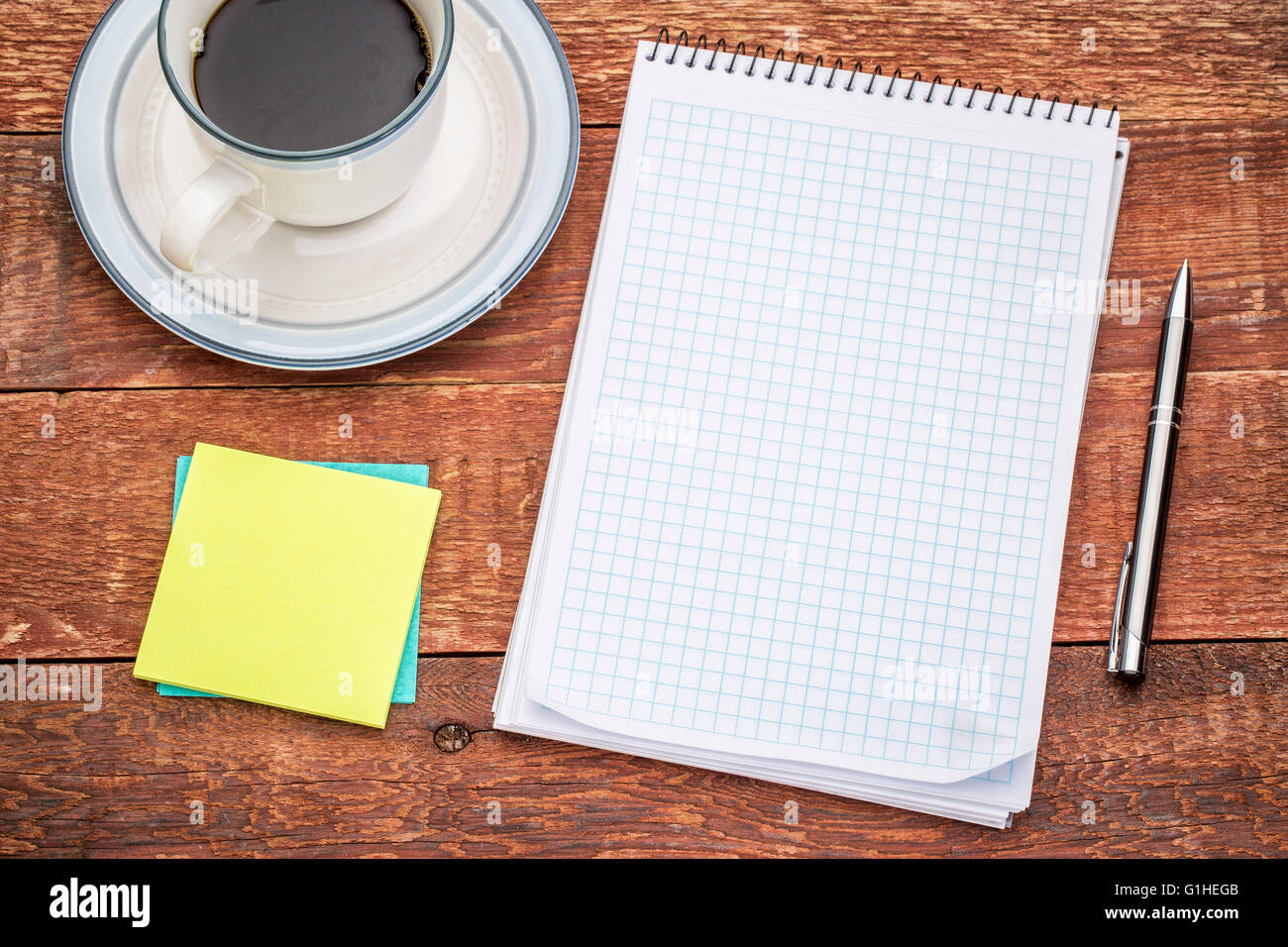 Rustic Sticky Note blank spiral notebook, sticky notes and a cup of coffee against rustic ...