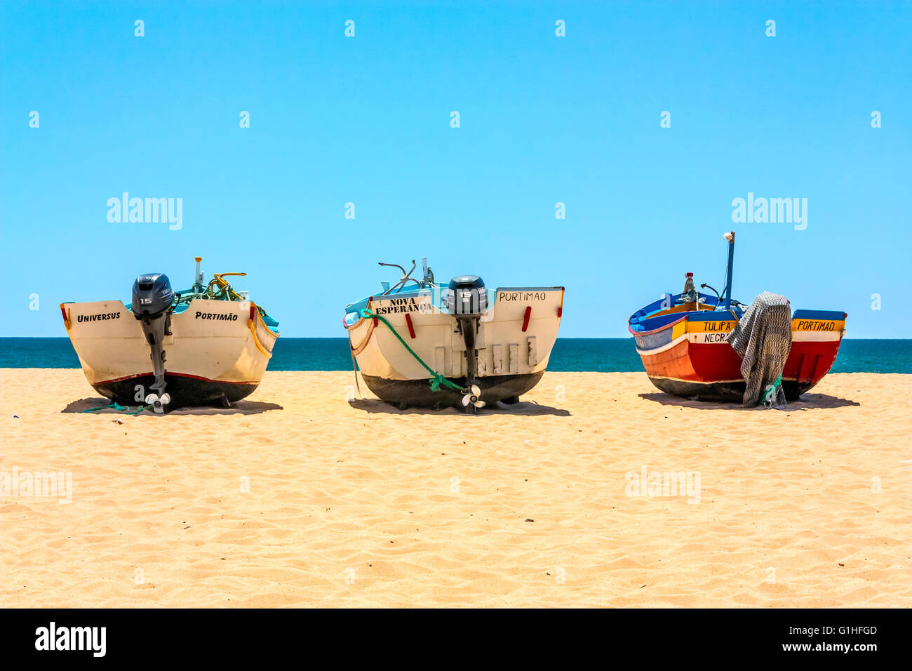 Three fishing boats at Fisherman's Beach, Armacao de Pera, Portugal Stock Photo