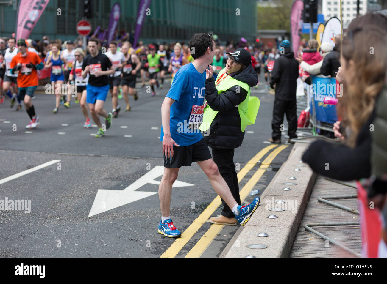 A marathon runner suffering from cramp Stock Photo Alamy