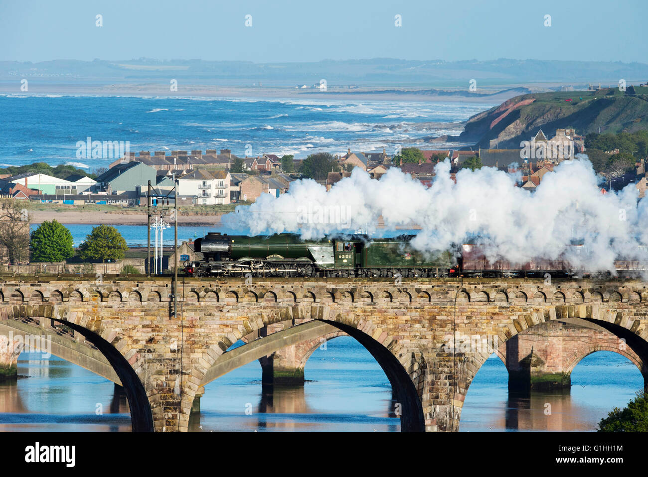 The Flying Scotsman crosses the Royal Border Bridge at Berwick upon Tweed on route between York and Edinburgh, on May 14th 2016. Stock Photo