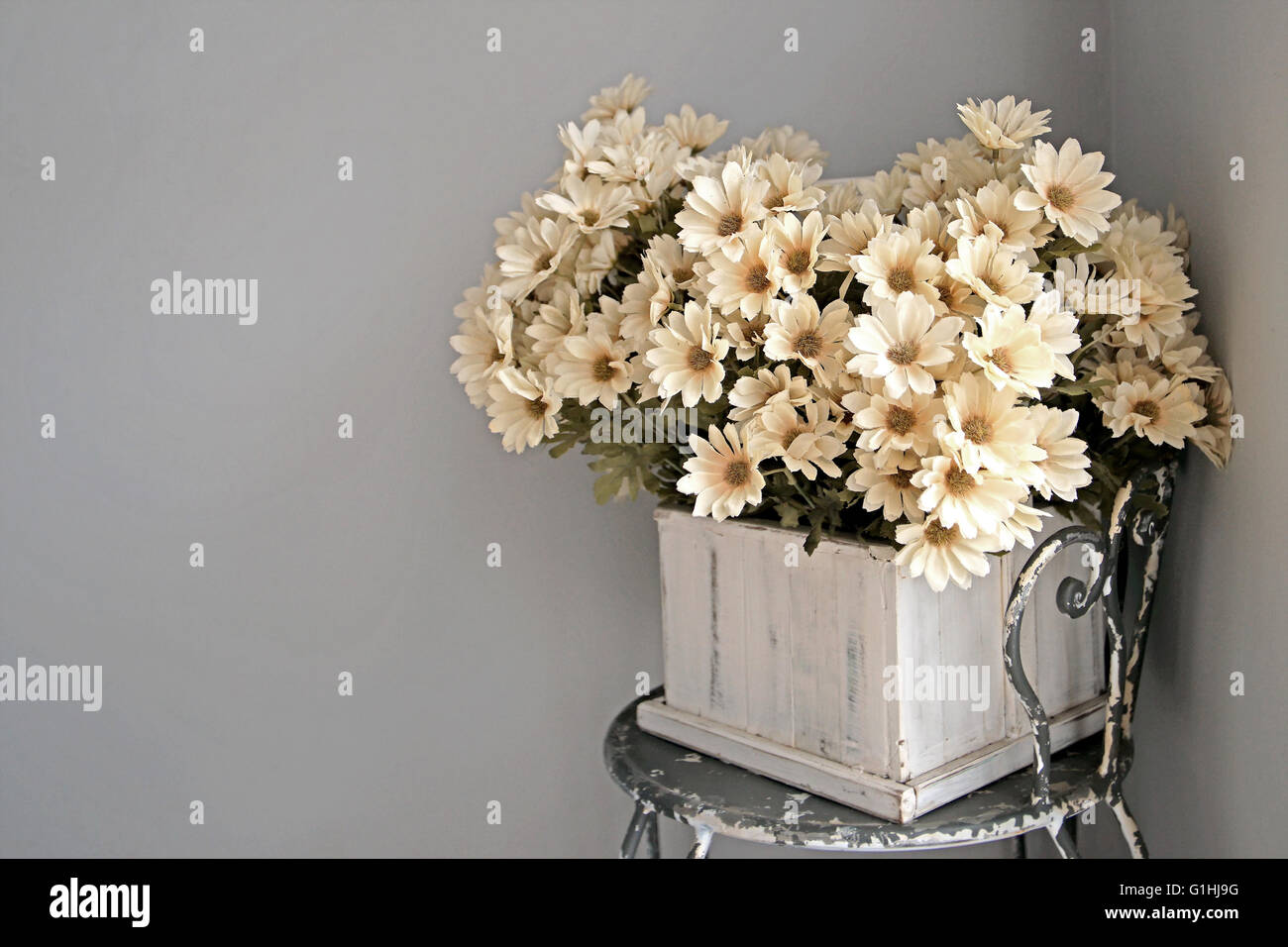 colorful artificial flower in flowerpot on the table Stock Photo