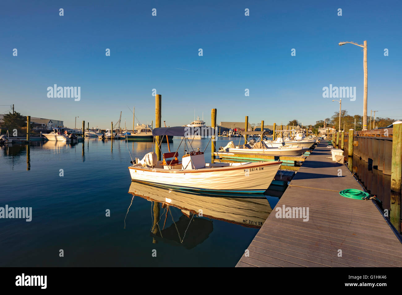 Millway Marina, Barnstable, Cape Cod, Massachusetts in the fall autumn with wooden boats, clear blue sky, copy space. Stock Photo