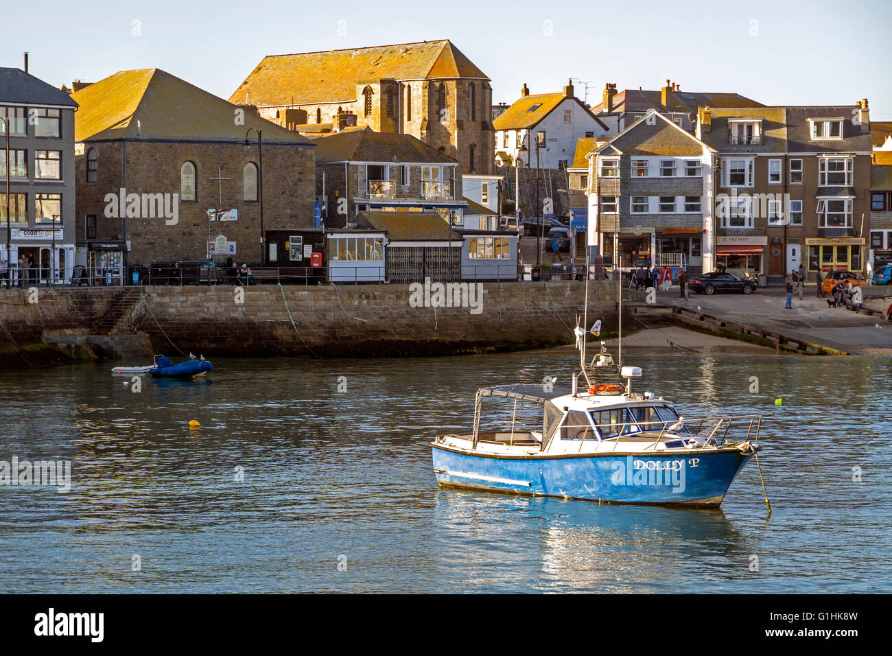 Blue boat in St Ives Harbour, Cornwall near sunset Stock Photo