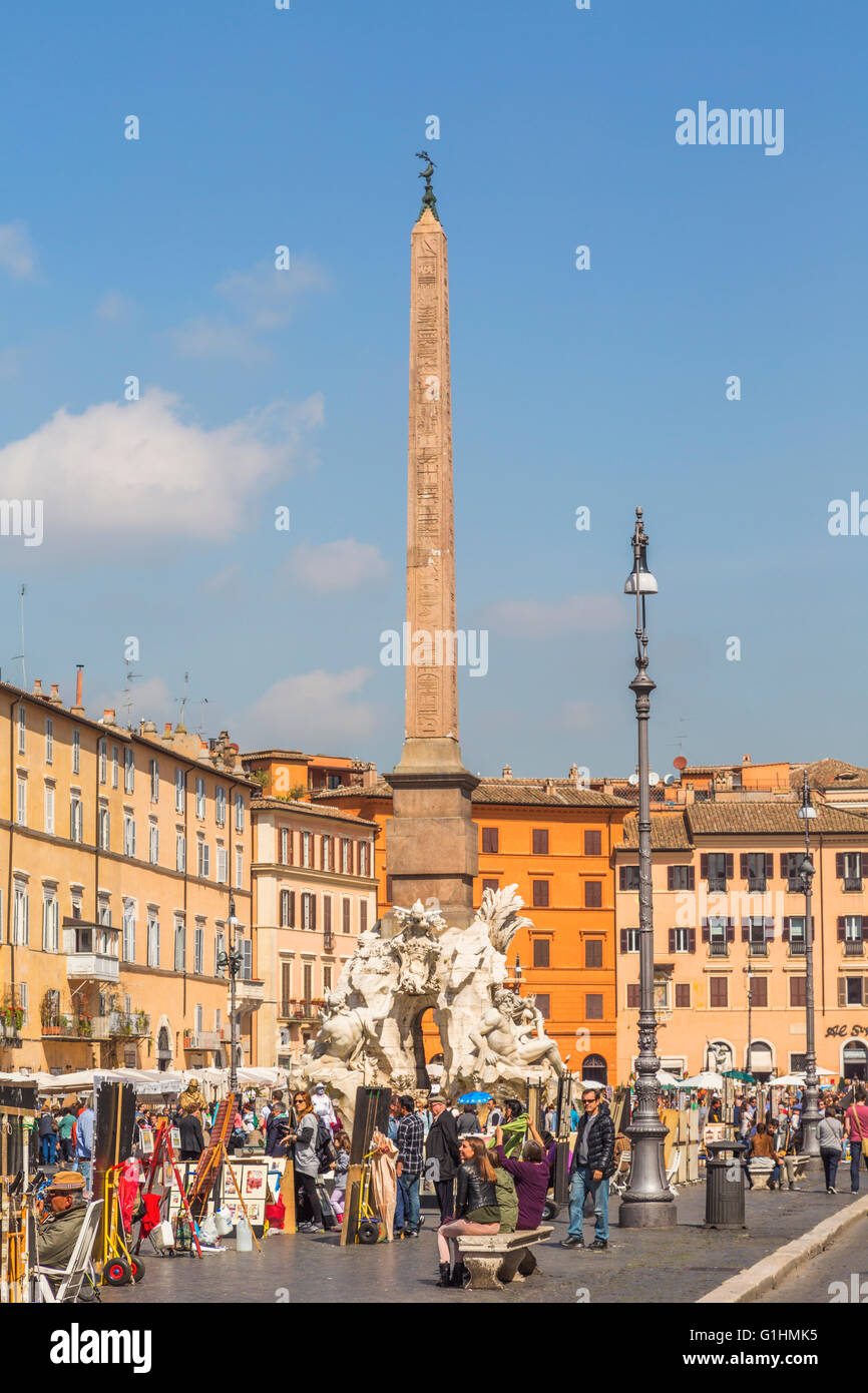 Rome, Italy.  Piazza Navona.   The obelisk of Domitian rising above the Fontana dei Quattro Fiumi or Fountain of the Four Rivers Stock Photo