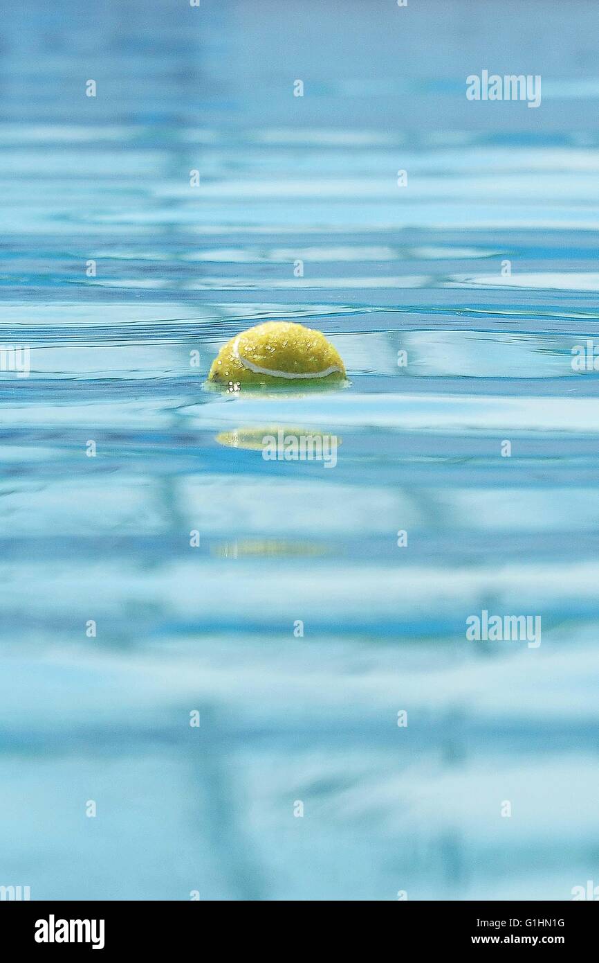 Just Tennis Ball Bobbing in Water Stock Photo