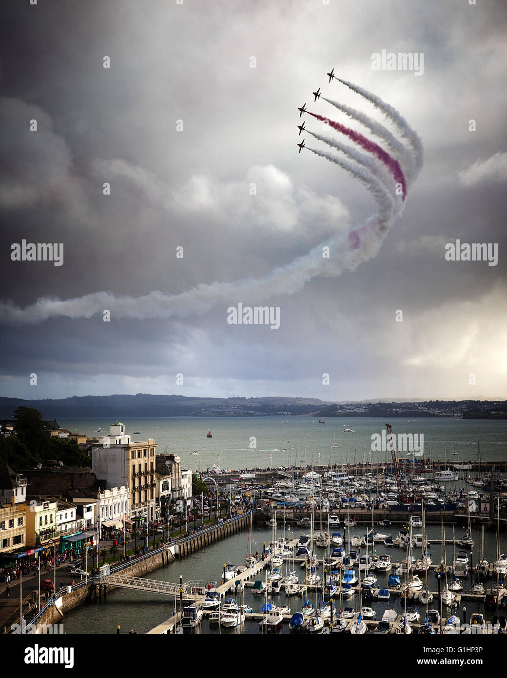 GB - DEVON: Red Arrows Royal Airforce Aerobatic Team above Torbay (Torquay Harbour in foreground) Stock Photo