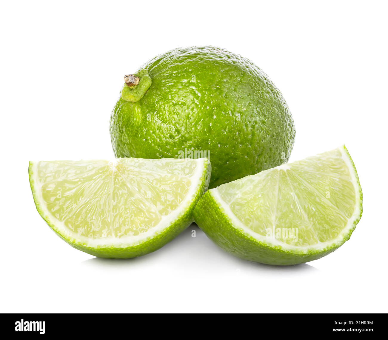 Lime. Whole lime with slices isolated on white background, with clipping path. Stock Photo