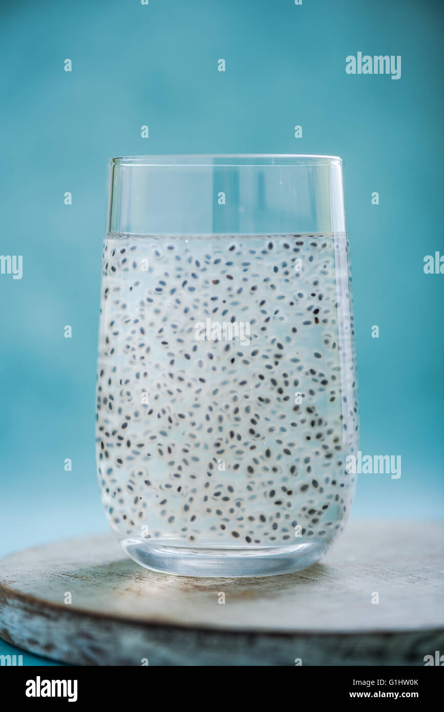 coconut water with basil seeds in glass on bright background Stock