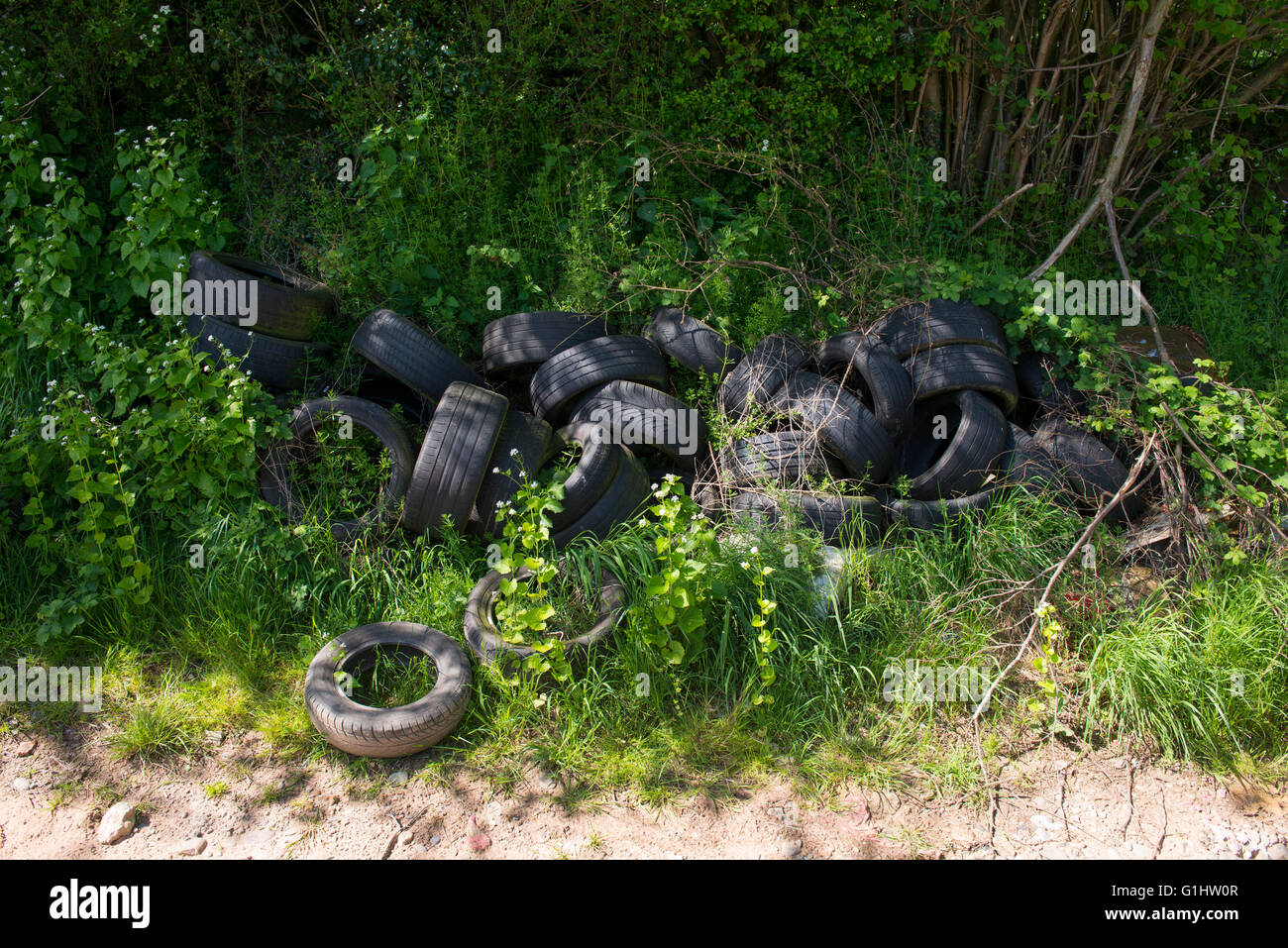 A pile of tyres next to a farm track in Shropshire, England, UK. Stock Photo