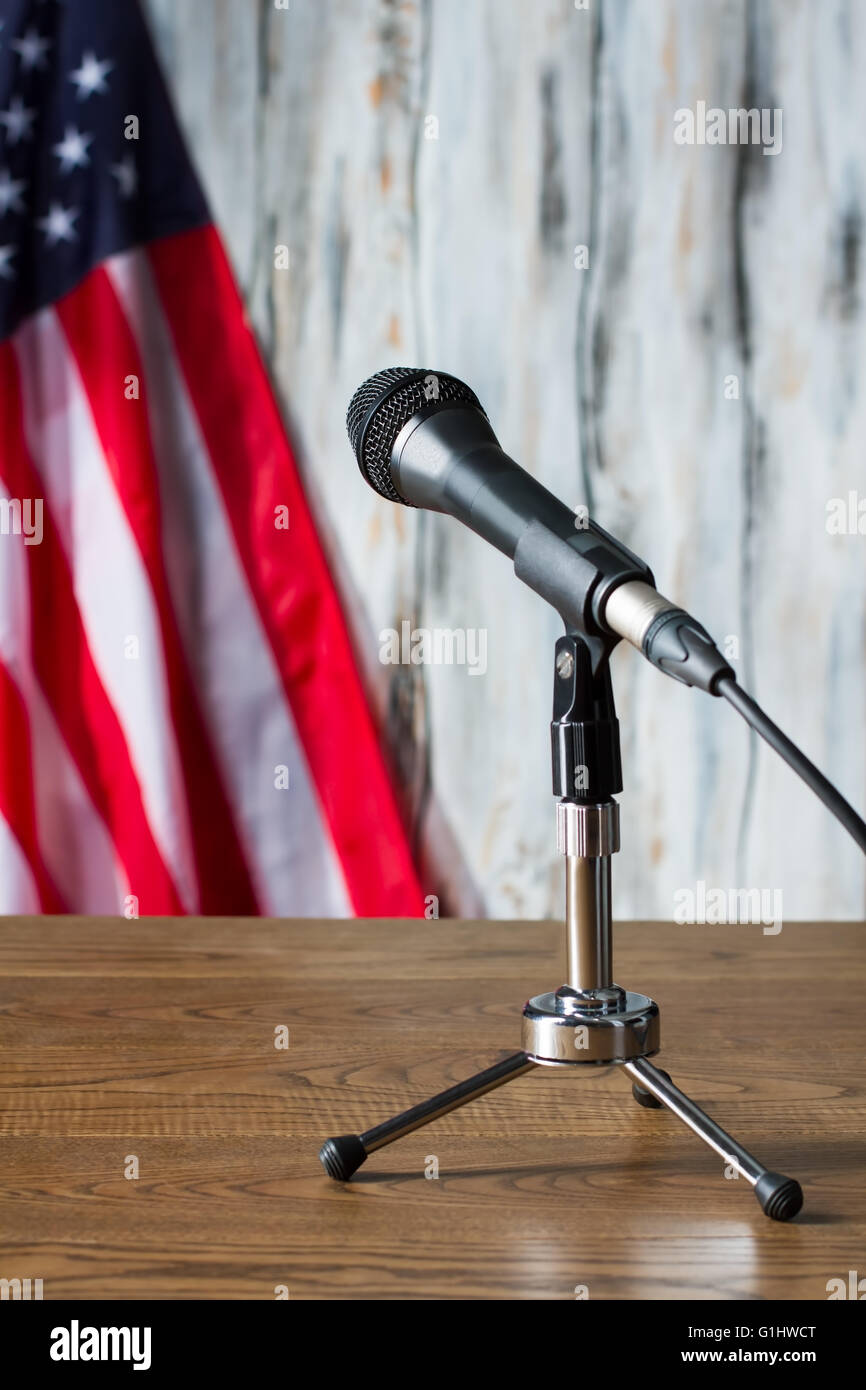 USA flag, table and microphone. Stock Photo