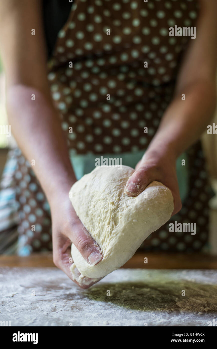 A woman kneads bread dough in her home kitchen Stock Photo - Alamy