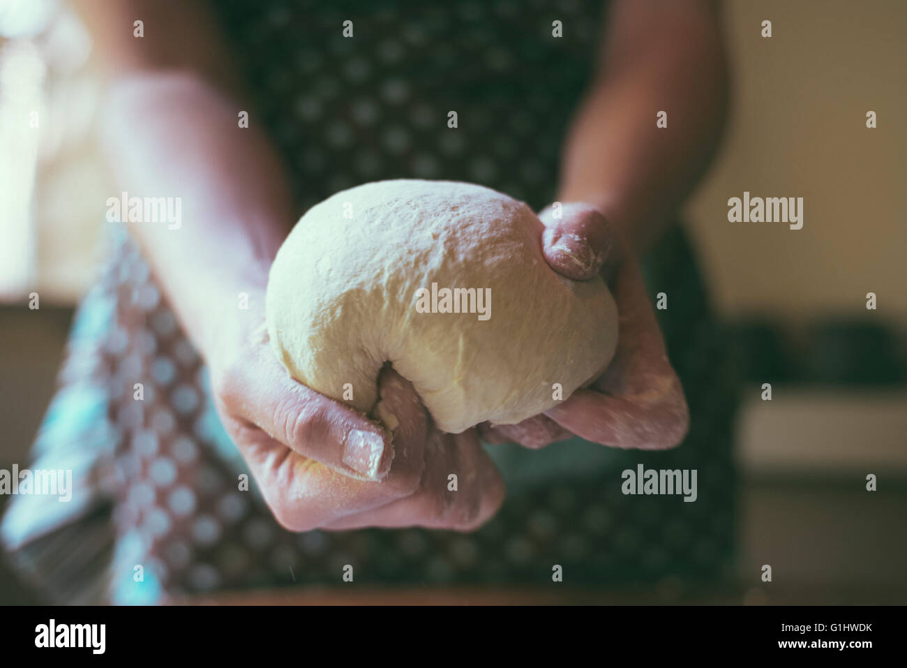 A woman kneads bread dough in her home kitchen Stock Photo - Alamy