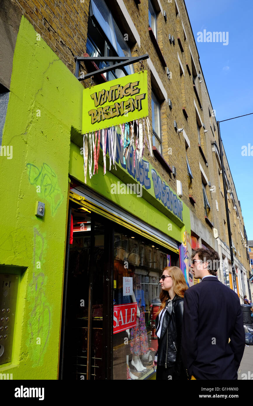 Smartly dressed man and woman looking at the Vintage basement Store in East London Stock Photo