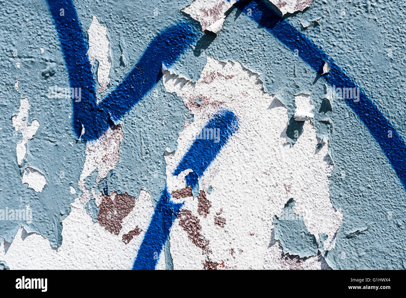 Graffiti and Peeling Paint on Wall Detail Background Stock Photo