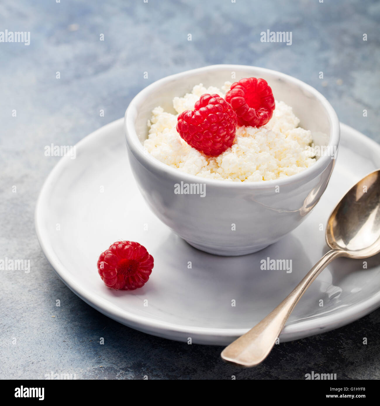 Fresh cottage cheese with berries, raspberries for breakfast closeup ...