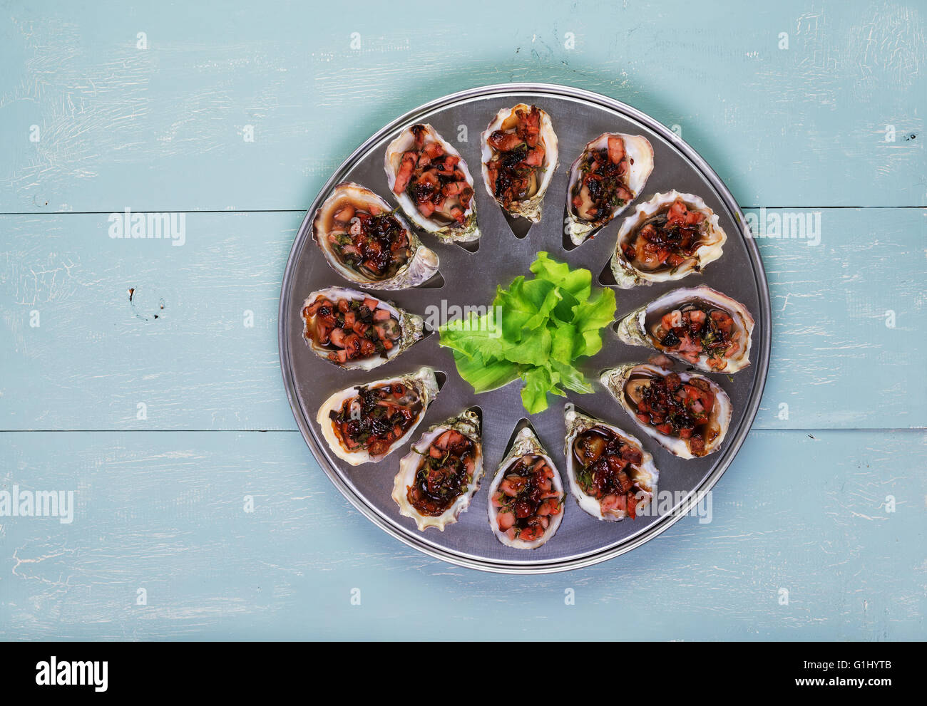 Oven baked oysters kilpatrick on special cooking and serving metal tray