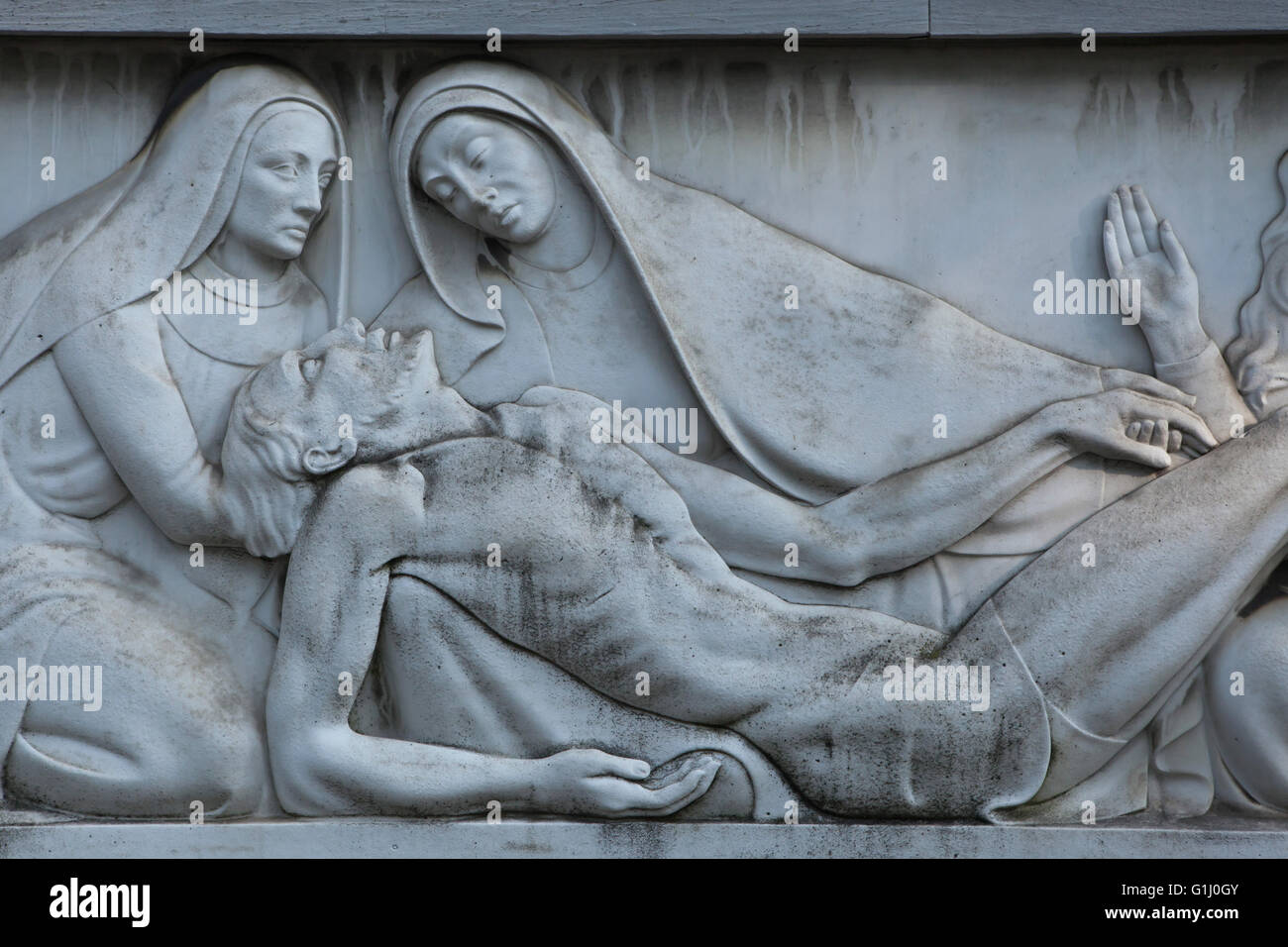 Lamentation of Christ (Pieta). Marble relief on the tombstone of the Ricotti Family at the Monumental Cemetery (Cimitero Monumentale di Milano) in Milan, Lombardy, Italy. Burial place of Doctor Pietro Ricotti (1876-1939) Stock Photo