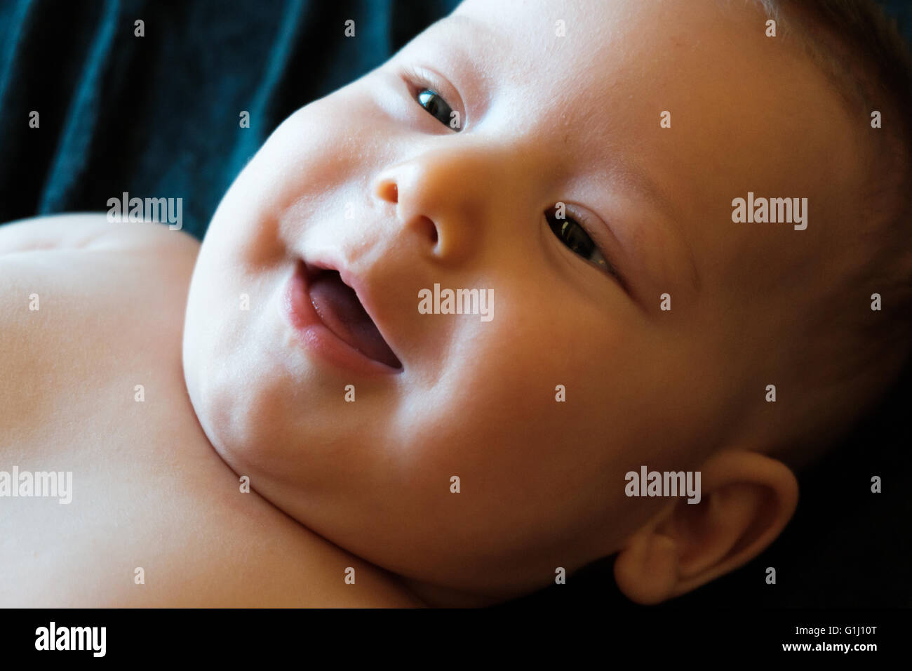 innocent baby on a black background Stock Photo