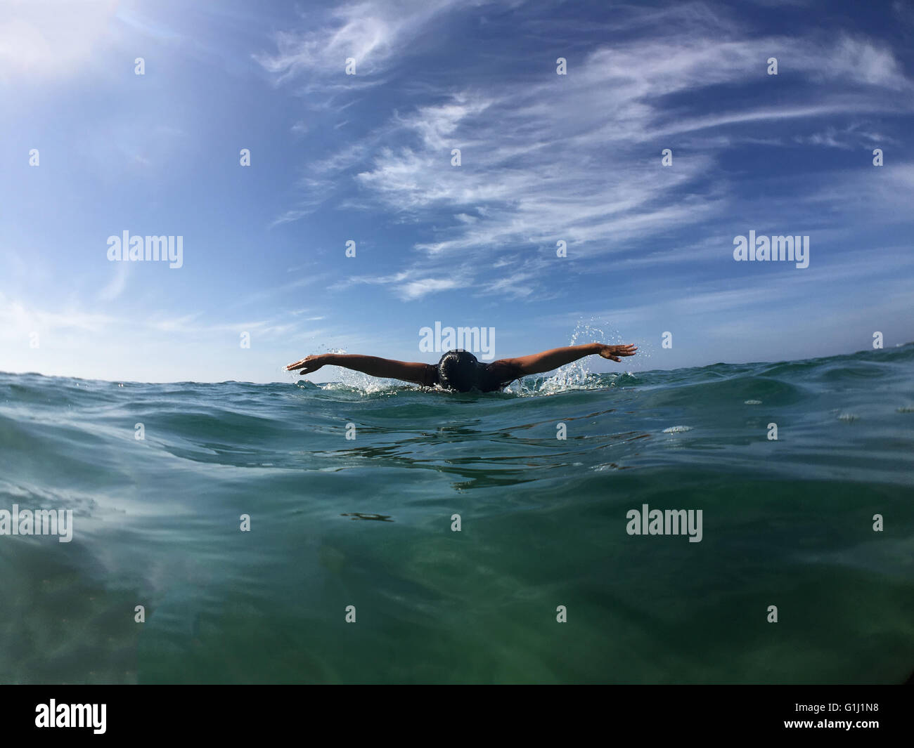 Woman swimming in ocean Stock Photo